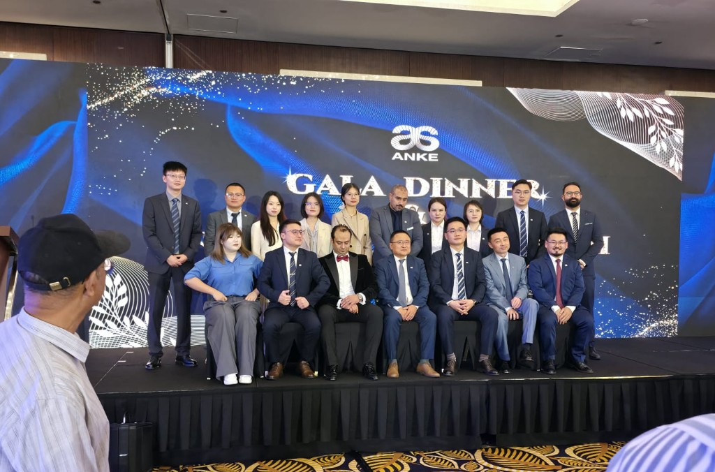 ANKE international team and partners at Gala Dinner — group photo on stage.